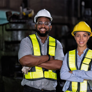Health safety and environmental team reviewing workplace compliance procedures at an industrial facility