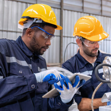 Health safety and environmental professionals conducting a workplace inspection at an industrial facility
