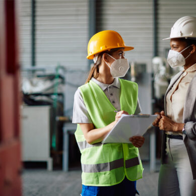 Integrated management system auditor conducting environmental and occupational safety compliance inspections at an industrial facility