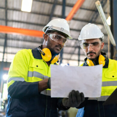 Internal auditor reviewing integrated management system compliance procedures in an industrial environment