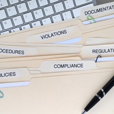 Information security professionals reviewing cybersecurity and data protection procedures in a corporate office environment