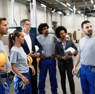 Lead quality auditor conducting a compliance inspection in a manufacturing environment