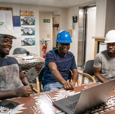 Quality management team reviewing operational procedures in a manufacturing environment
