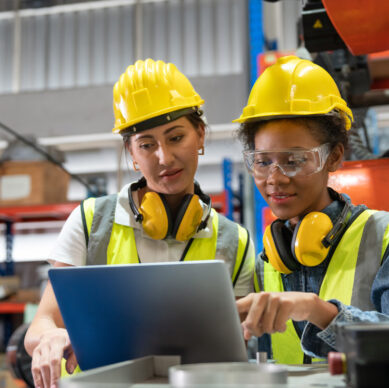 Manufacturing team reviewing mistake-proofing and quality control procedures in an industrial environment