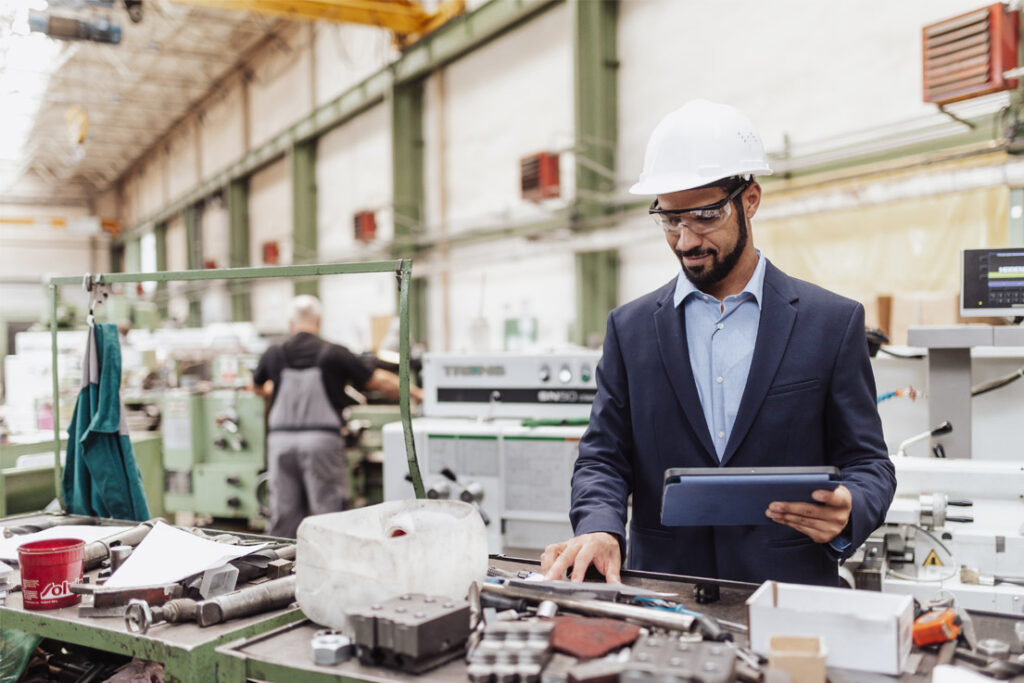 Quality and manufacturing professionals reviewing production approval and compliance procedures in an automotive manufacturing environment