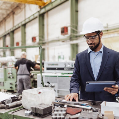 Quality and manufacturing professionals reviewing production approval and compliance procedures in an automotive manufacturing environment