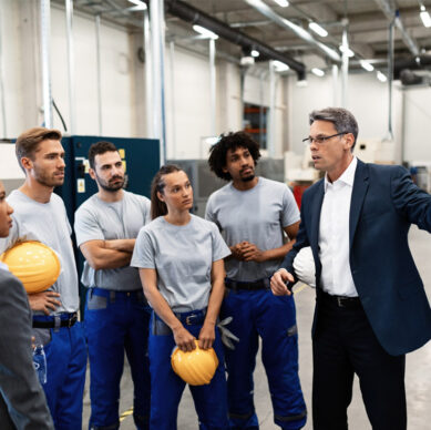 Quality management professionals implementing operational procedures in a manufacturing environment